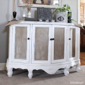 Chalk painted cabinet used to store electronics.