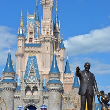 Castle at Magic Kindom with statue of Walt Disney and Mickey.