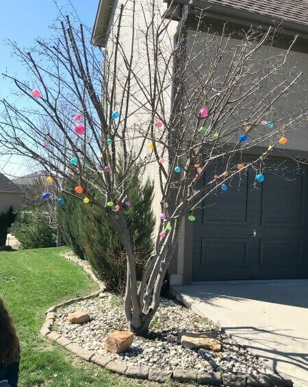 Multi colored plastic eggs in outdoor spring / Easter decor