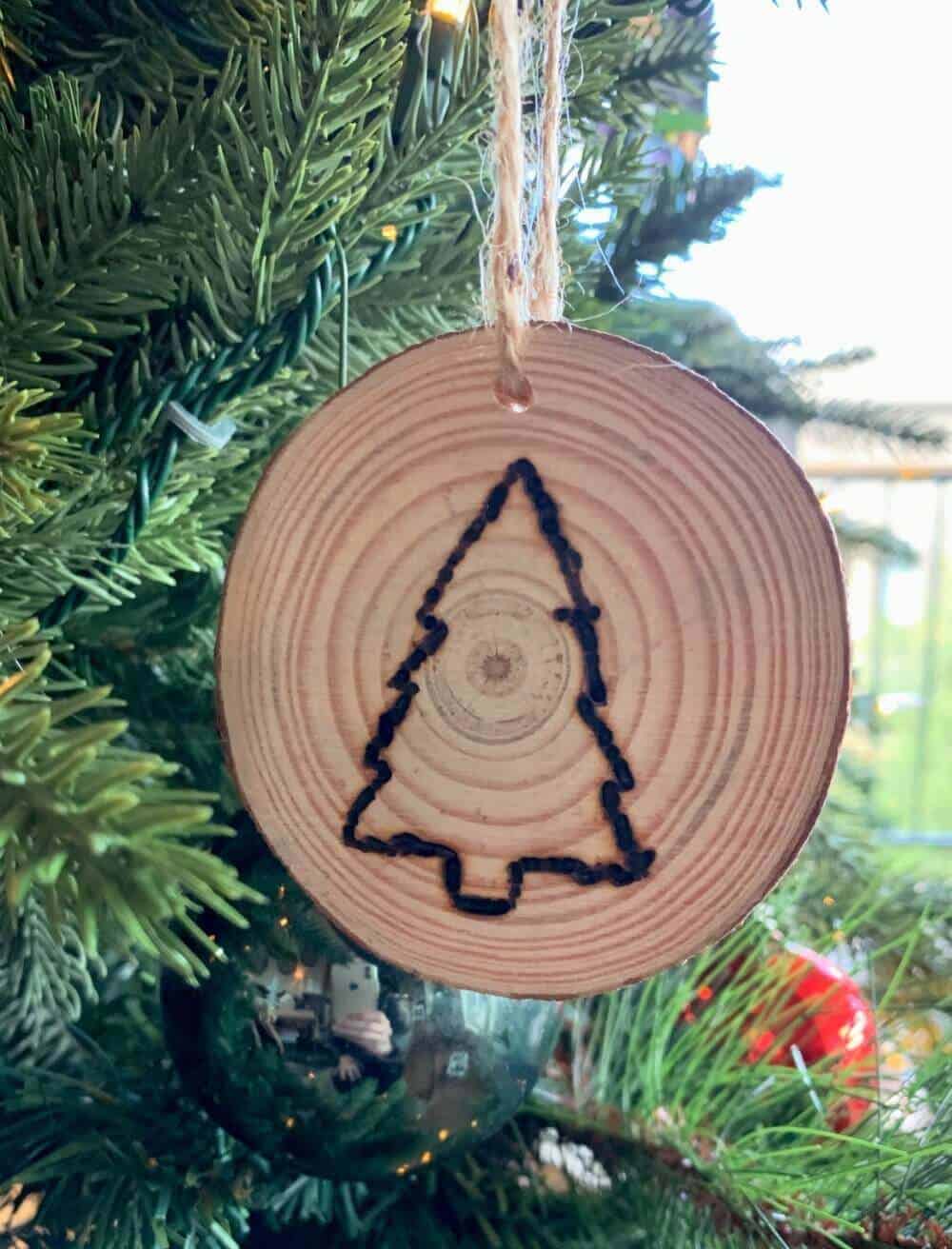christmas tree on wood slice with wood burning pen.
