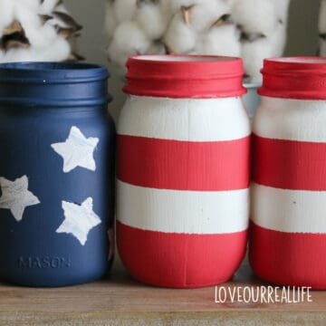 4th of July mason jars painted to look like the American flag for July decor.