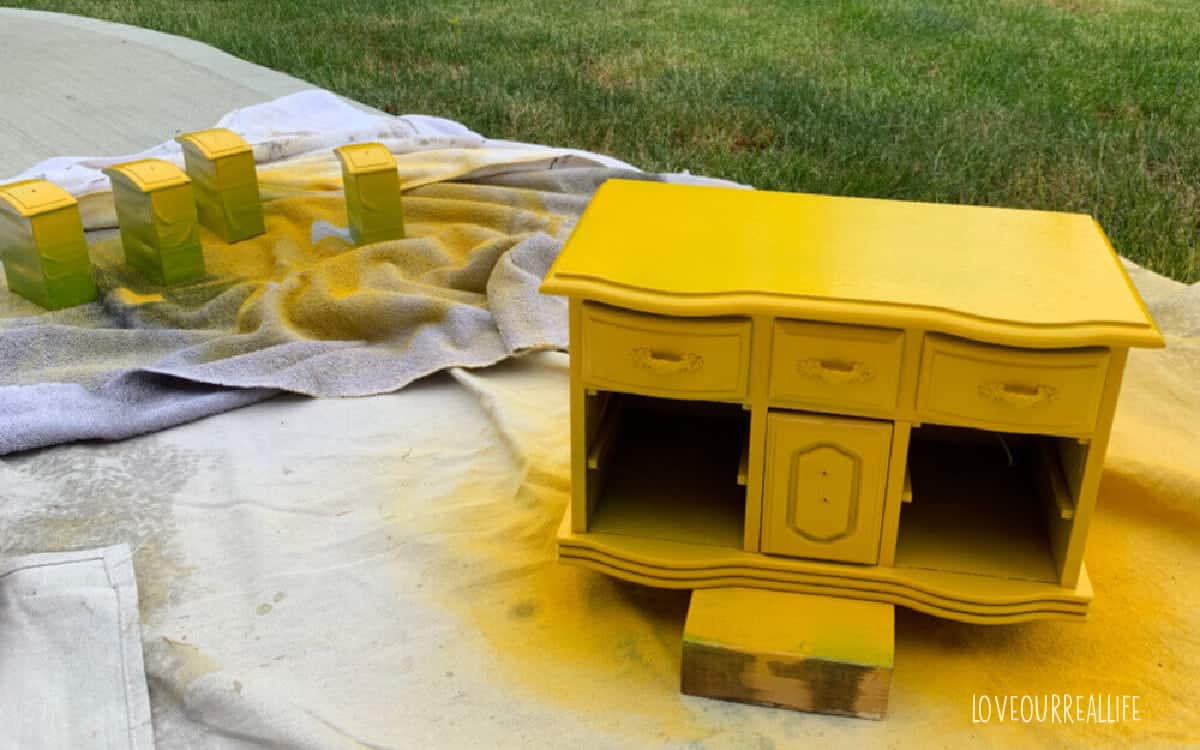 First coat of yellow spray paint on jewelry box and drawers.