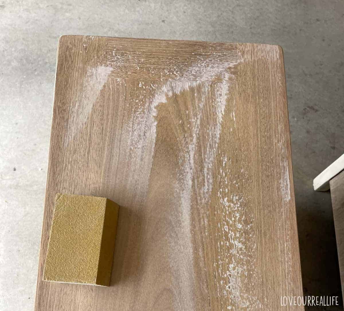 Using a sanding pad to sand wood after it was bleached.