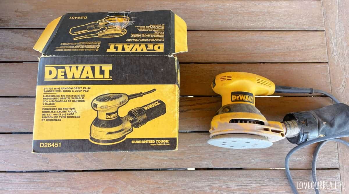 Dewalt orbital palm sander on table beside original packing box.