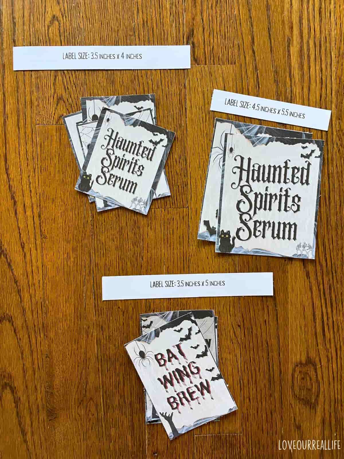 Halloween bottle labels cut out and sitting on floor.