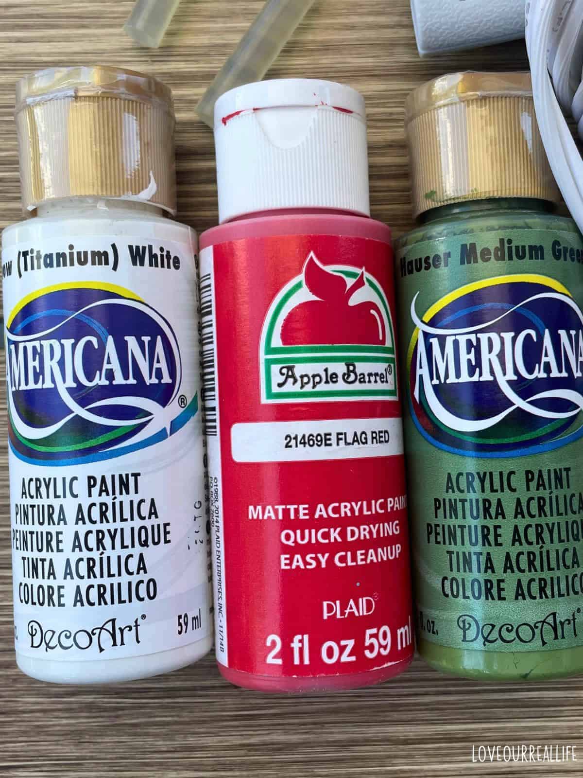 Red, white, and green acrylic craft paint.