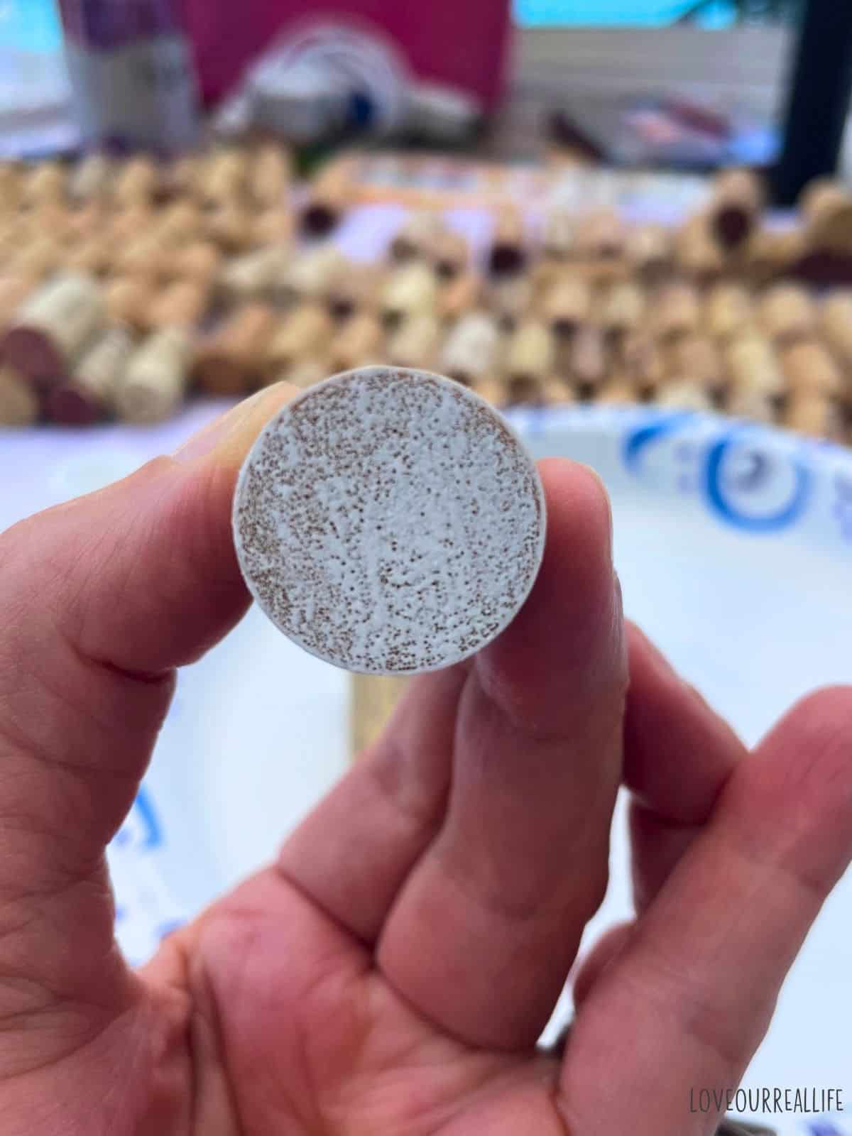 White paint on end of wine cork.