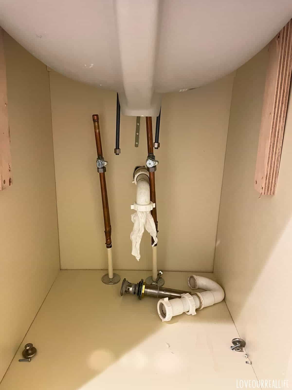 Plumbing under bathroom vanity.