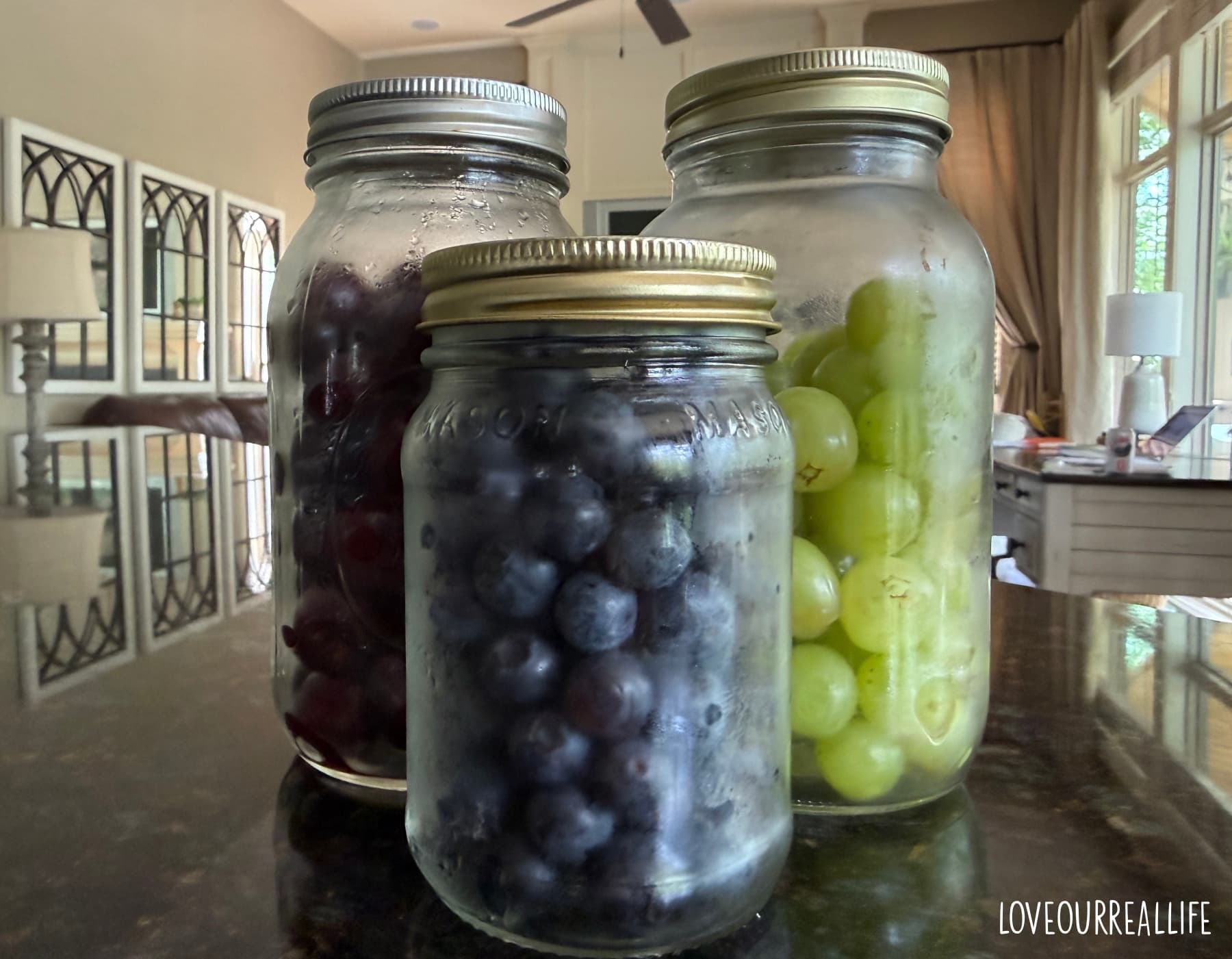 Grapes, cherries, and blueberries in mason jars.