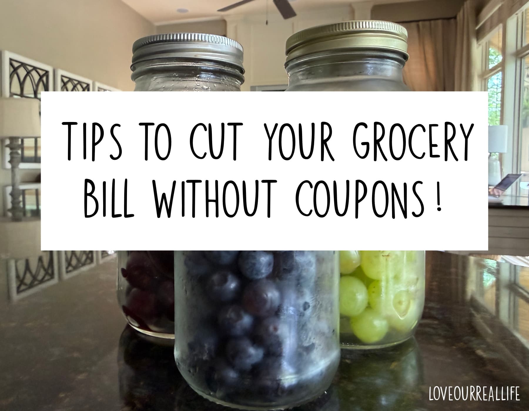 Fruit in mason jars with text overlay "tips to cut your grocery bill without coupons".